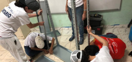 Volunteers setting up a new bookshelf